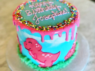 Dinosaur blue and green and pink sprinkle drip cake