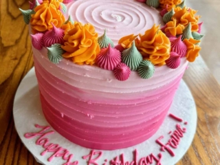 shades of pink with orange green dollops ombre cake