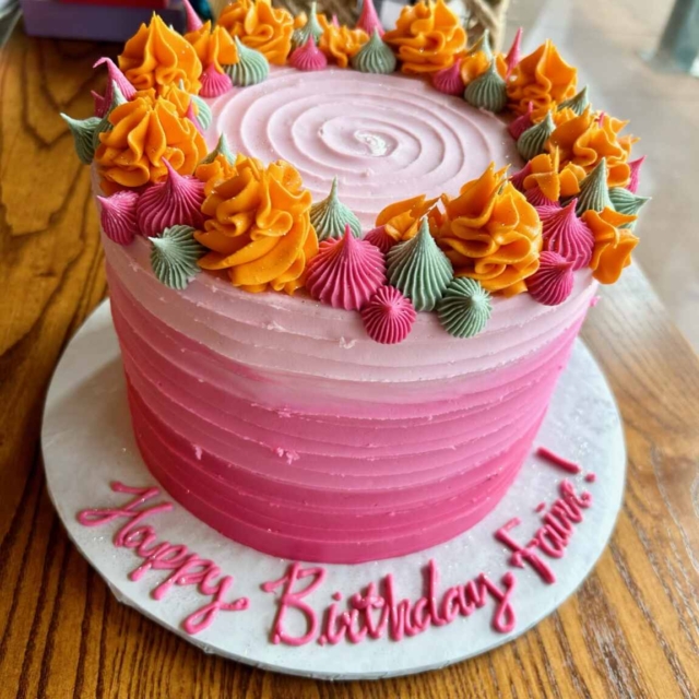 shades of pink with orange green dollops ombre cake