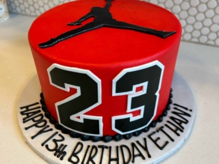 red with 23 number and michael jordan in dunk position
