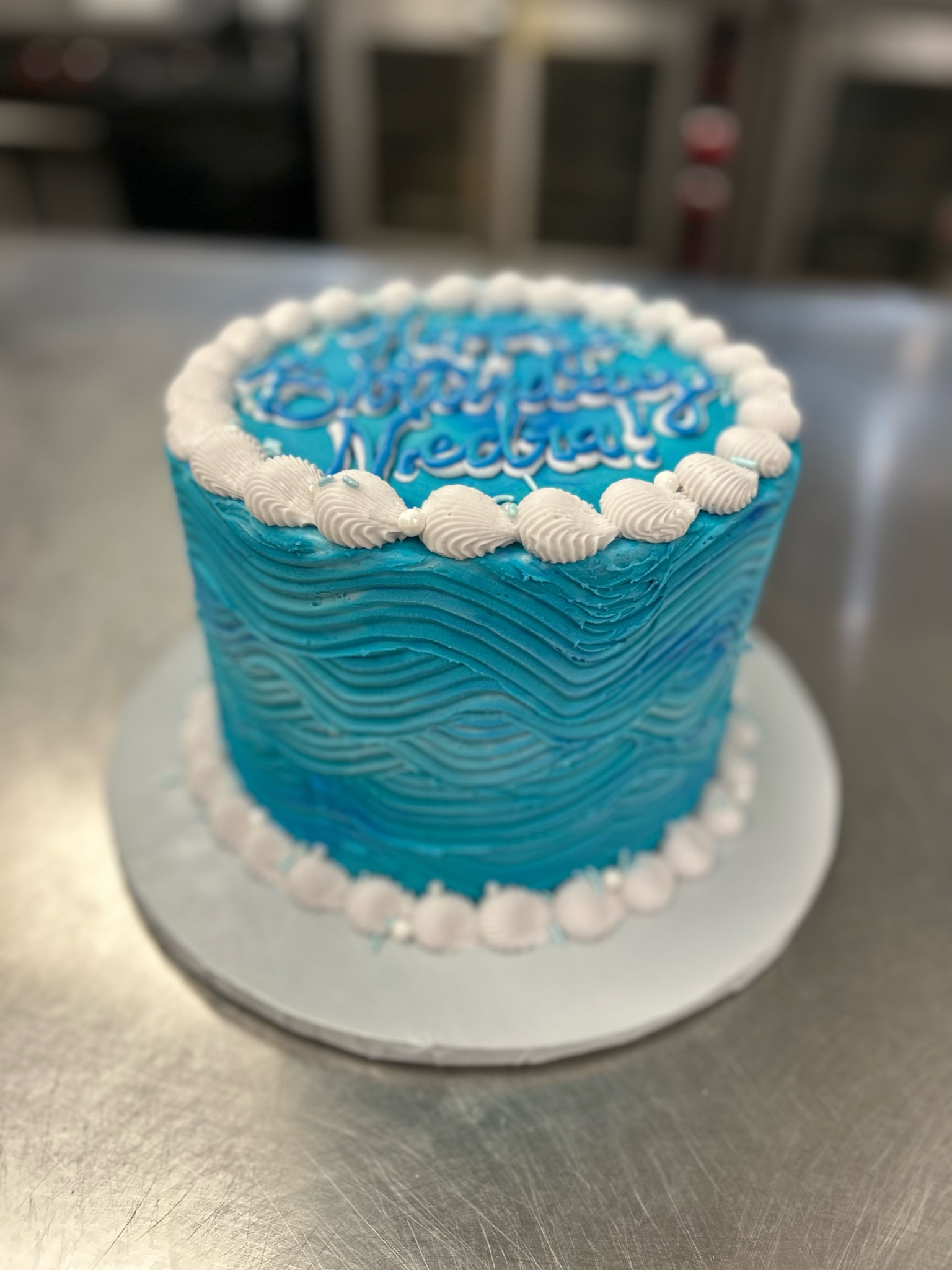 shell piping wavy blue icing cake