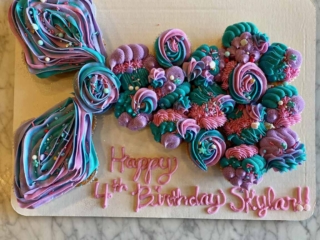 Mermaid-cupcake-board purple pink blue cupcake in mermaid tail with sprinkles