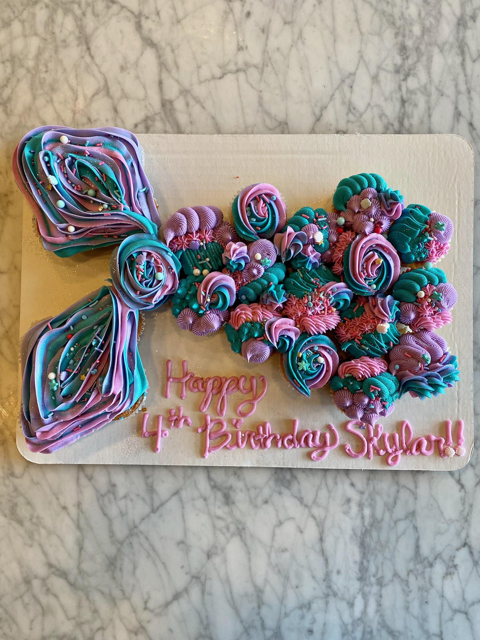 purple pink blue cupcake in mermaid tail with sprinkles