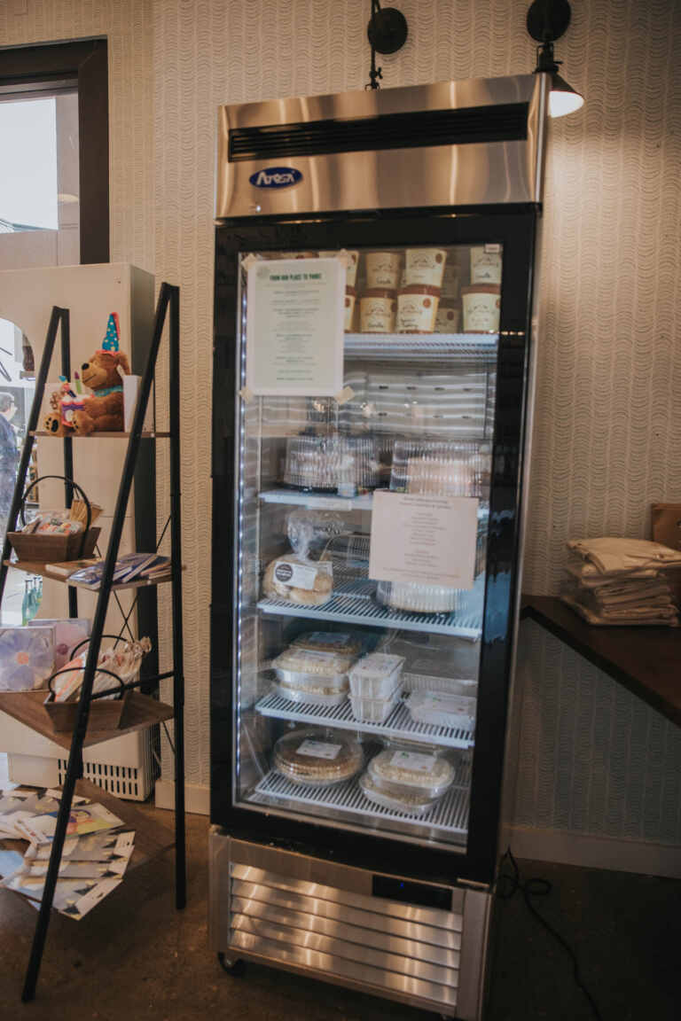 Refrigerator pictured showing it stocked with Grab and Go cakes, that cake be customized with a message on top.